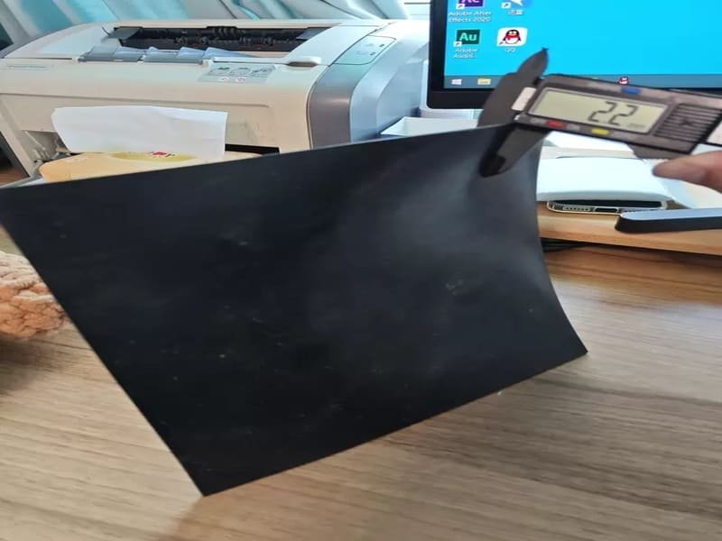 Sandbags weighting down curled rubber flooring edges